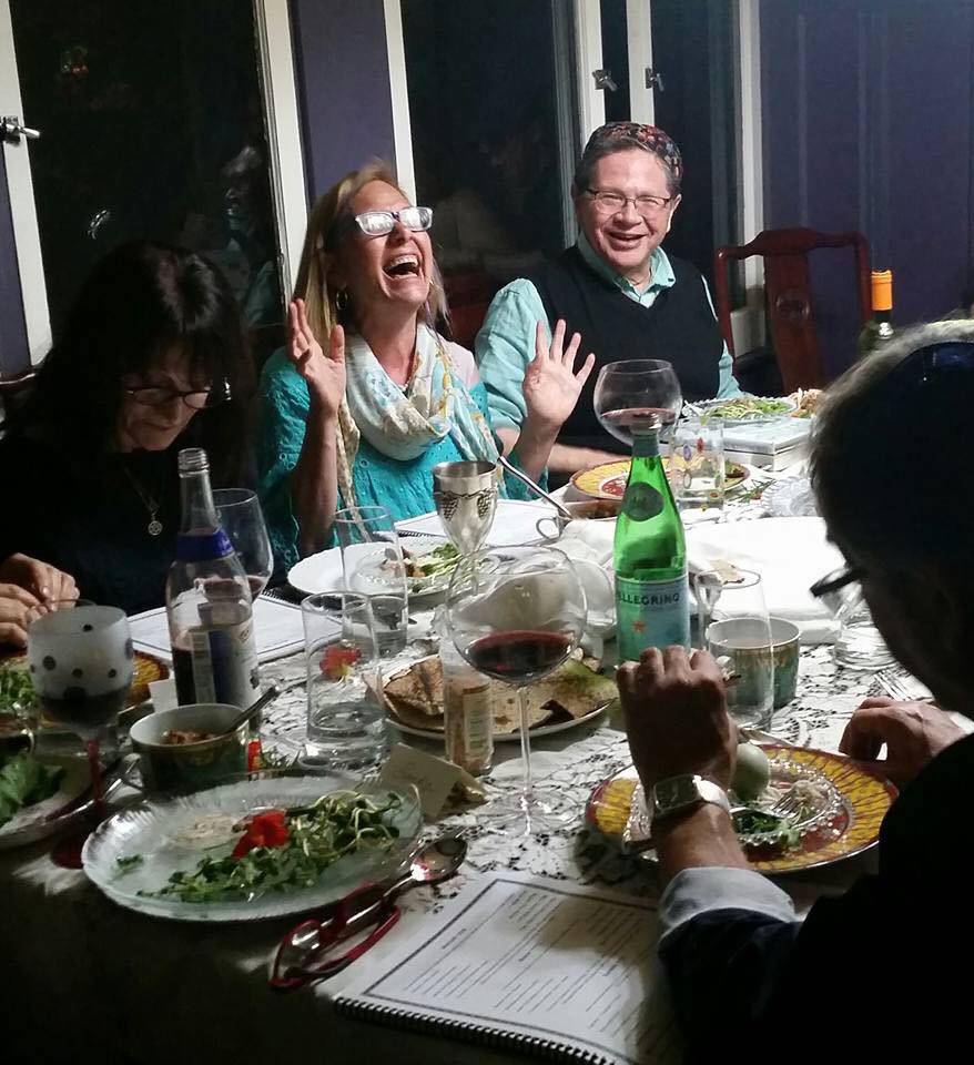 A Group of People Sitting for Dinner With Wine One