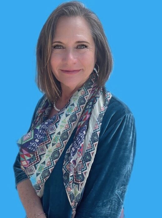 A woman wearing a scarf and a blue background.